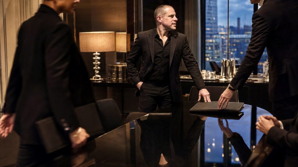 Barry Roberts wearing black tailoring in a private London interior.