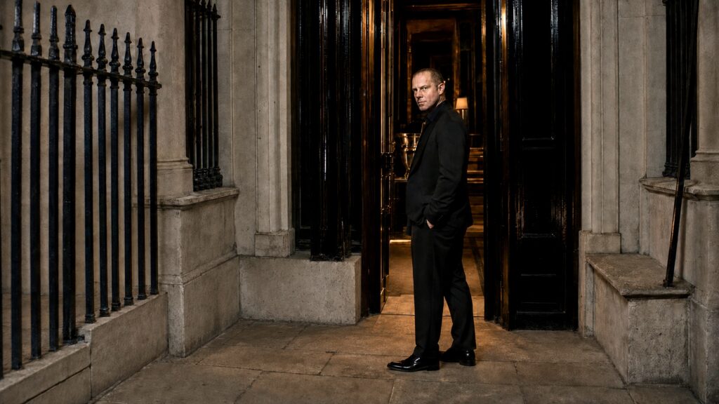 Barry Roberts arriving at a black-tie dinner inside a London townhouse.