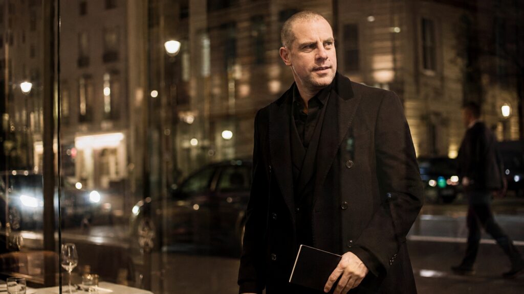 Barry Roberts in black evening tailoring at a private London meeting.